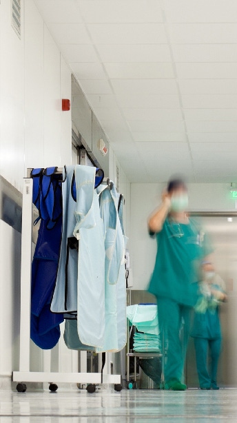 Blurred figures of people with medical uniforms in hospital corridor